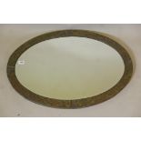 An Arts & Crafts hammered metal wall mirror with copper details and bevelled glass, 34" x 24"