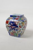 A Wucai porcelain jar with dragon and lotus flower decoration, Chinese six character mark to base,