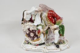 A continental porcelain figure of a Regency couple seated on a bench, 10" wide