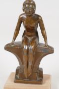 An Art Deco bronzed spelter figure of a seated female nude, 7" high