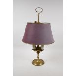 A brass four branch toleware lamp with an adjustable shade, 19" high