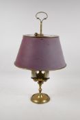 A brass four branch toleware lamp with an adjustable shade, 19" high