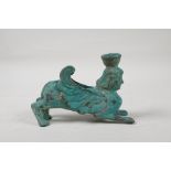 An antique bronze candlestick in the form of a Harpy, with verdigris patina, 5½" long