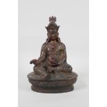 A Sino Tibetan bronze figure of buddha seated on a lotus throne, carrying a vajra, with remnants