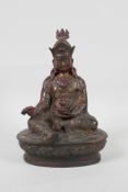 A Sino Tibetan bronze figure of buddha seated on a lotus throne, carrying a vajra, with remnants