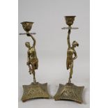 A pair of cast brass candlesticks, the columns as Mercury and Venus, on plinth bases, 11" high