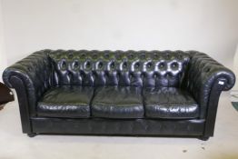 A black leather three seater Chesterfield, 78" long