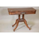 A Regency brass inlaid rosewood card table, raised on ring turned columns, platform base and splayed