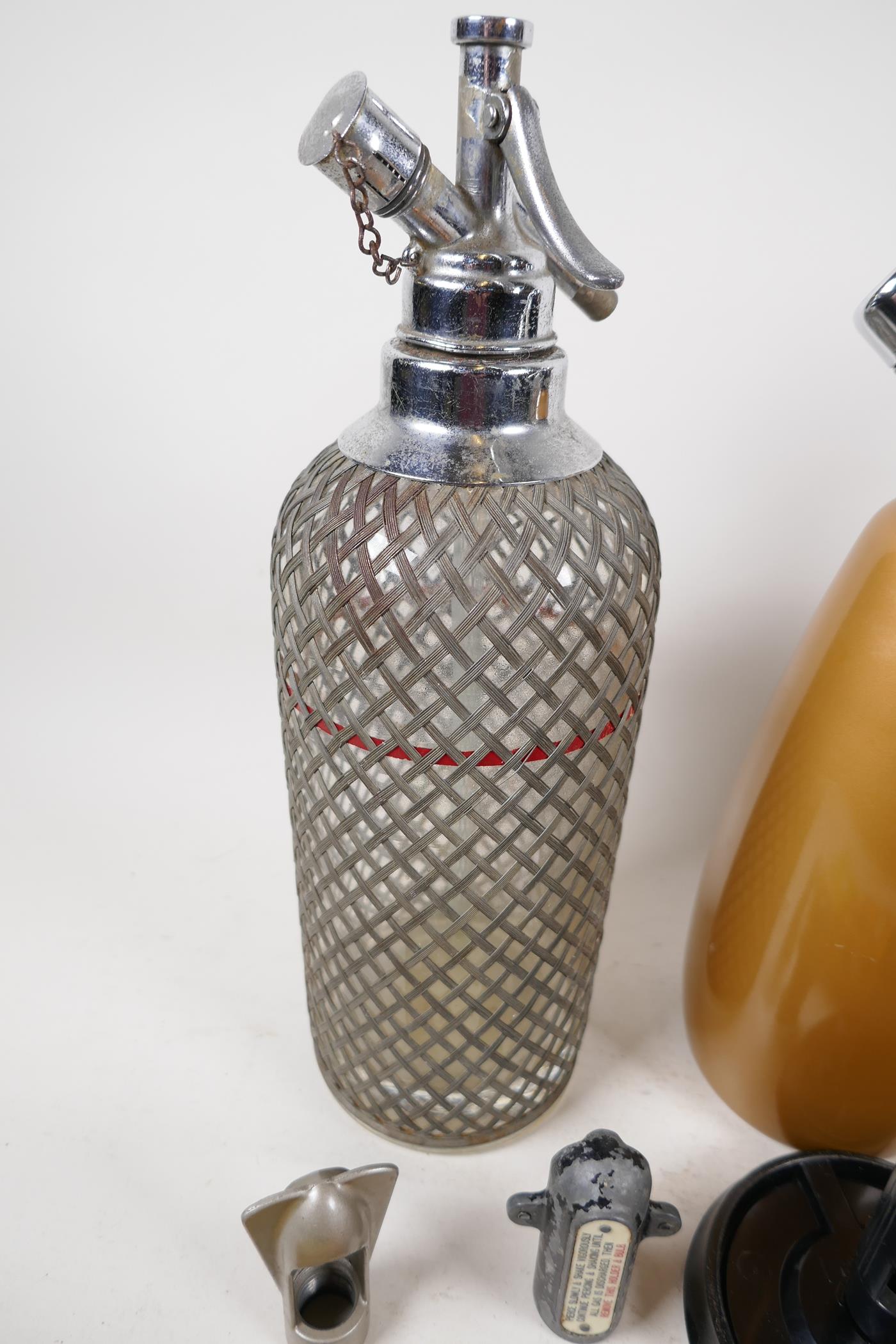 Two vintage wire bound soda syphons together with one other, with accessories and bulbs - Image 2 of 3