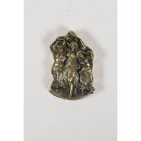 A brass vesta case with raised decoration of three semi clad women, 1½" x 2"