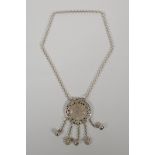 A Chinese white metal pendant necklace with pierced zodiac animal decoration, 2½" diameter