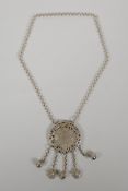 A Chinese white metal pendant necklace with pierced zodiac animal decoration, 2½" diameter
