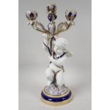 A Copeland porcelain table candelabra with three branch floral candle holders supported by winged