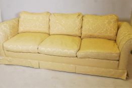 A three seater Chesterfield settee upholstered in yellow brocade fabric, 90" wide