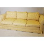 A three seater Chesterfield settee upholstered in yellow brocade fabric, 90" wide