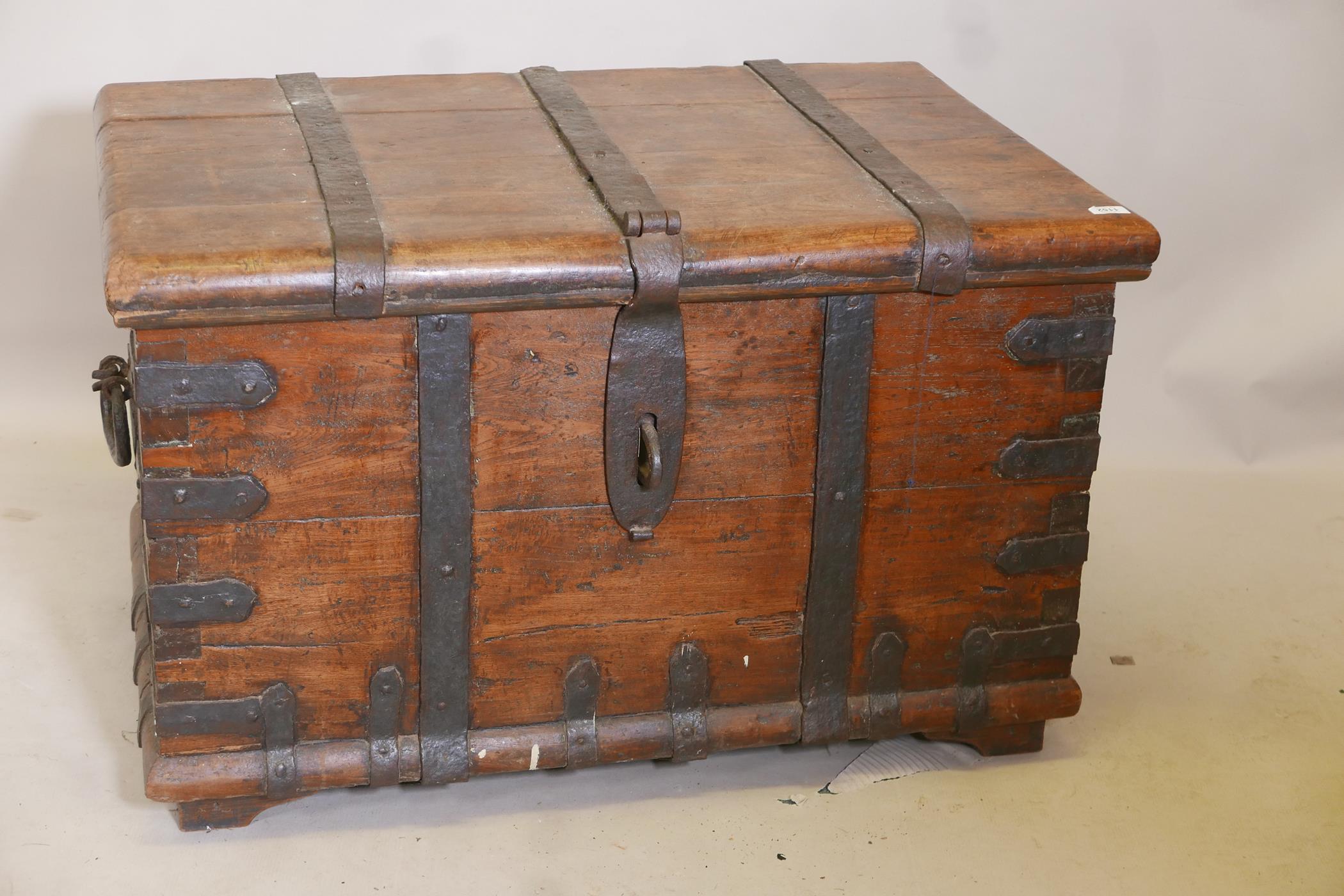 An antique hardwood silver chest with forged iron straps and carrying handles, 39" x 26" x 24"