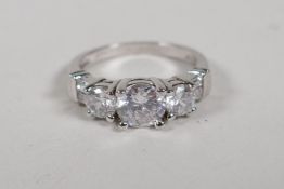 A 925 silver and cubic zirconia three stone dress ring, size N/O