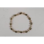 A 10ct yellow gold, diamond and tourmaline set bracelet, 6" long