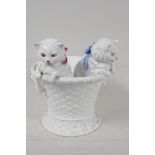 A continental porcelain jardiniere modelled as two kittens in a basket, 7½" high