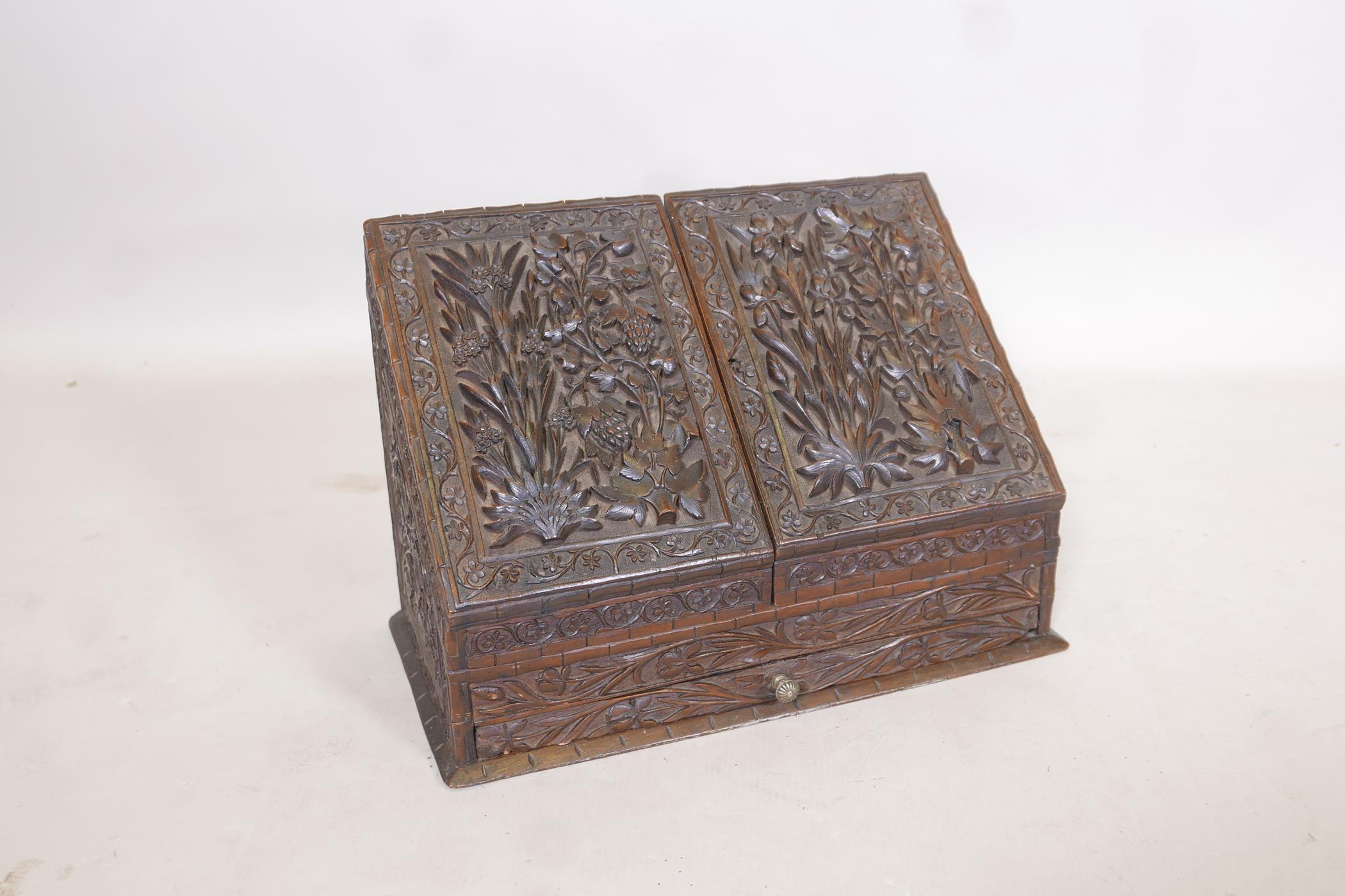 A C19th Anglo Indian wood stationery box with fall front and two doors over a single drawer, well
