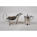 A hallmarked silver sauce boat, Birmingham 1924, and a silver mustard pot with blue glass liner,