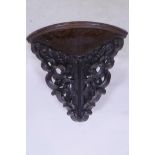 A C19th mahogany corner wall bracket with well carved decoration, 14" x 16"