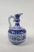 A Chinese blue and white porcelain pourer with a ribbed body, with scrolling lotus flower