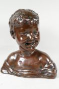 A filled copper bust of a young child, signed Donatello, 13" high