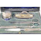 A boxed manicure set with hallmarked silver handles and cover, Birmingham 1918