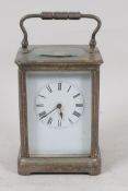 A plated brass cased carriage clock with white enamel dial and Roman numerals, 5½" high