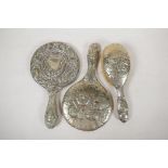 A C19th silver plated dressing table mirror and hairbrush embossed with the five cherubs design, 11"