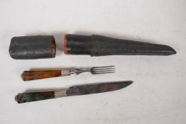 An antique continental travelling knife and fork set with agate handles, in a shagreen case, 8½"