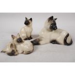 A Beswick pottery figure of a Siamese cat, No 1558, 7½", together with a Royal Doulton figure of two