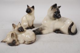 A Beswick pottery figure of a Siamese cat, No 1558, 7½", together with a Royal Doulton figure of two