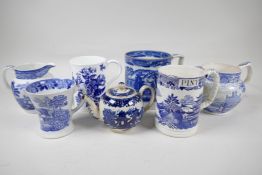 A collection of early C19th blue and white pottery mugs, jugs and small teapot
