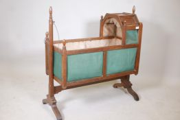 A C19th fruitwood swinging baby's cradle, 38" long, 40½" high