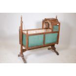 A C19th fruitwood swinging baby's cradle, 38" long, 40½" high