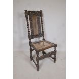 A late C18th/early C19th oak barleytwist chair with a cane seat and back, and carved floral details,
