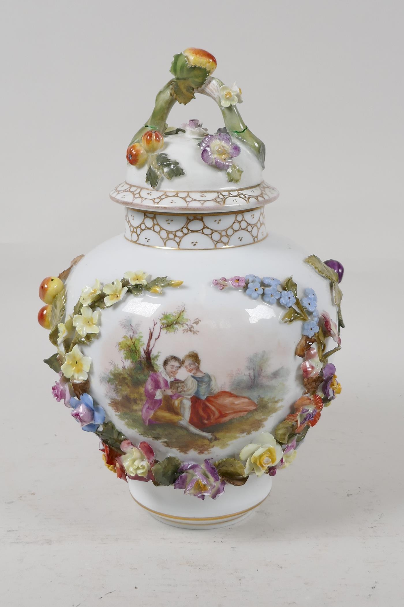 A German porcelain vase and cover, decorated with a courting couple, and encrusted with fruit and
