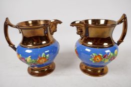 A pair of C19th lustreware mask jugs decorated with embossed flowers, 6" high