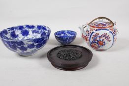 Three pieces of oriental porcelain to include an Imari palette tea pot, and two black and white