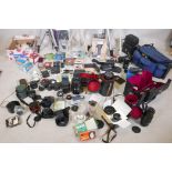 A quantity of photography equipment, tripods, lightmakers, lenses by Canon, Yashica, Minolta,