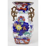 A two handled pottery vase, painted with flowers in the Chinese manner, blue seal mark to base,