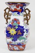 A two handled pottery vase, painted with flowers in the Chinese manner, blue seal mark to base,