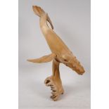 A carved driftwood figure of a humpback whale, 14" high