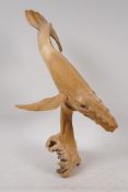 A carved driftwood figure of a humpback whale, 14" high