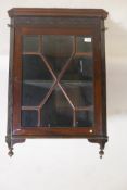 A C19th mahogany hanging corner display cabinet, with blind fret frieze over a single astragal
