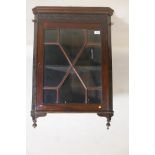 A C19th mahogany hanging corner display cabinet, with blind fret frieze over a single astragal