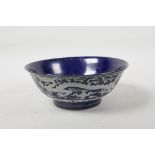 A powder blue glazed porcelain rice bowl with white enamel dragon decoration, six character mark