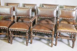 A set of eight antique oak and studded leather dining chairs, 35" high